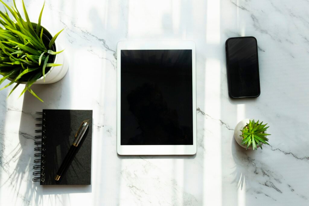 Tablet and smartphone on desk, top view